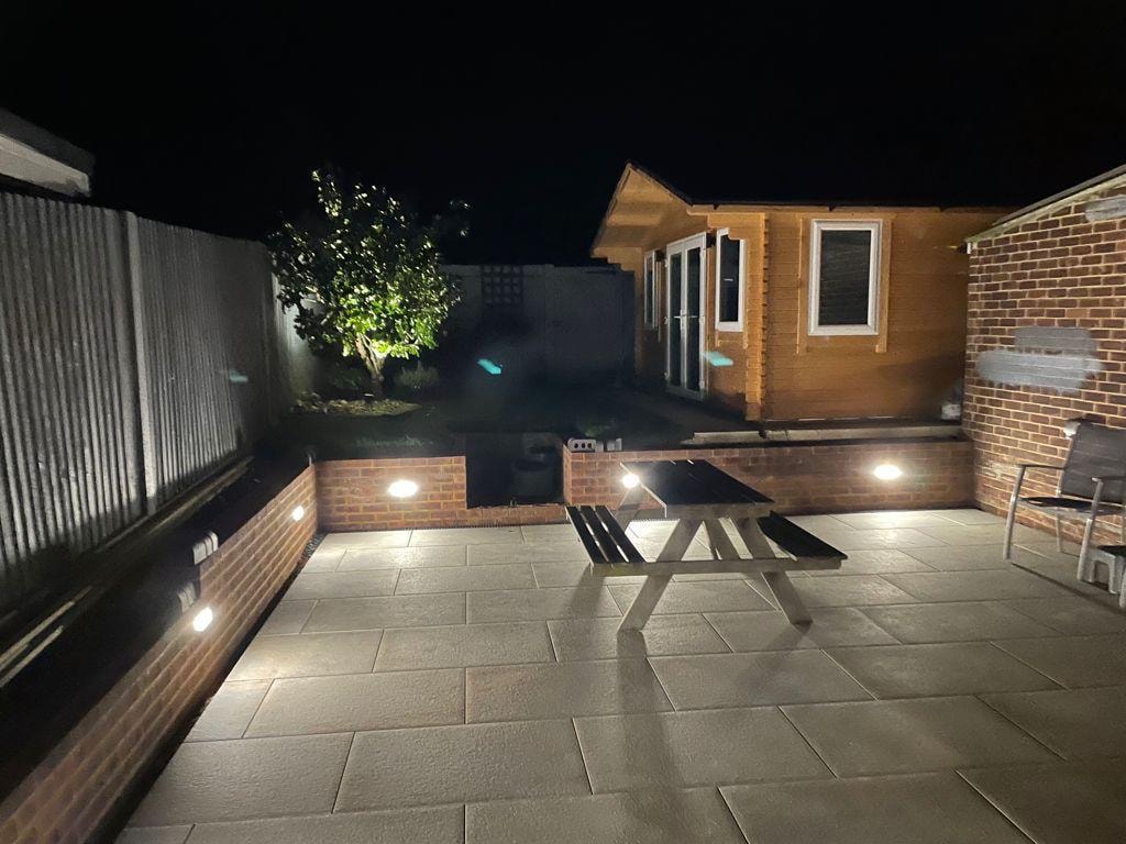 Landscaped stone patio with garden beds