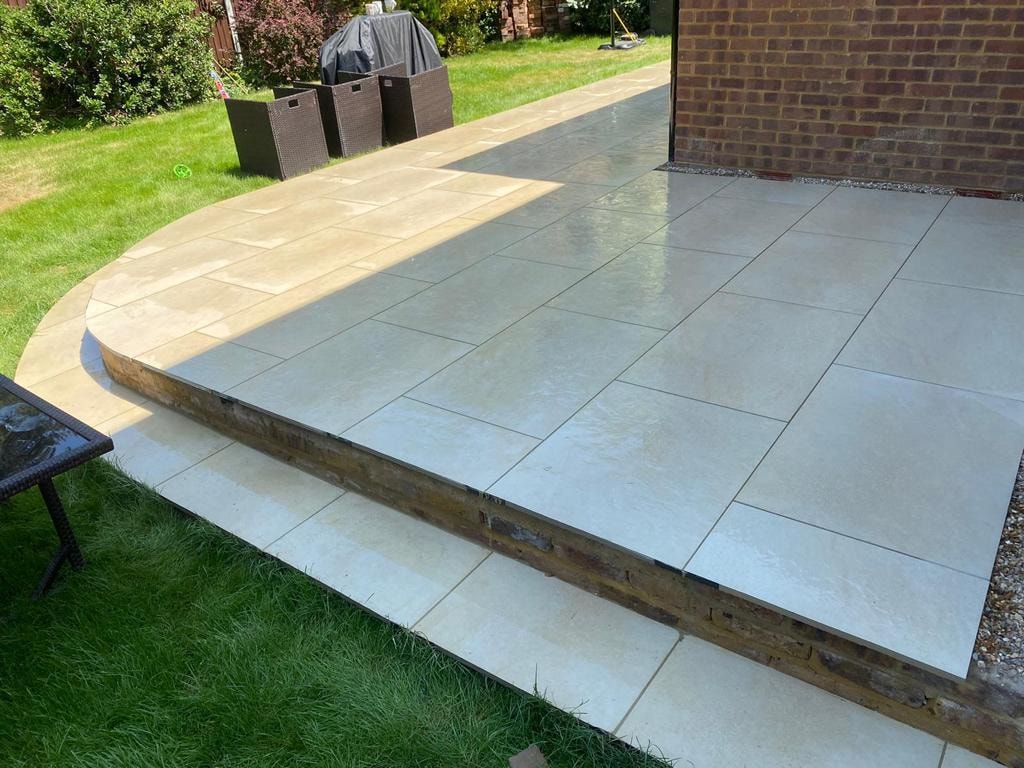 Tiled raised garden patio with lawn