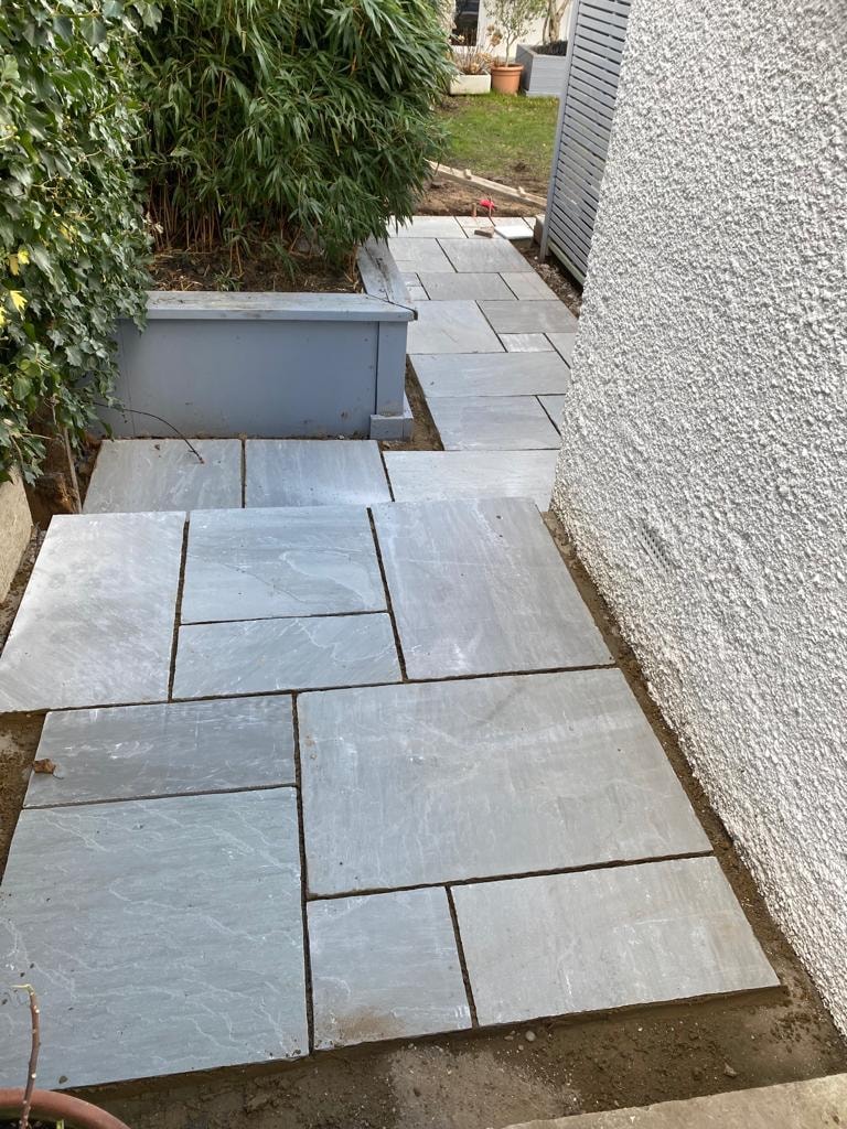 Slate stone garden pathway beside a house