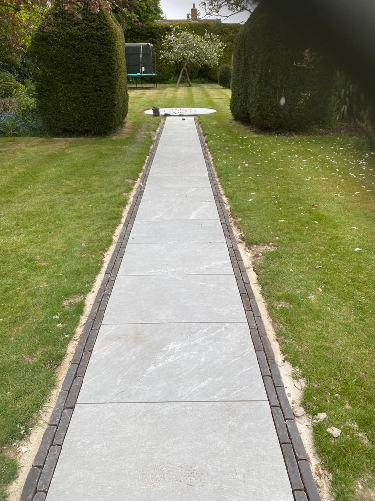 Stone walkway leading toward a house entrance