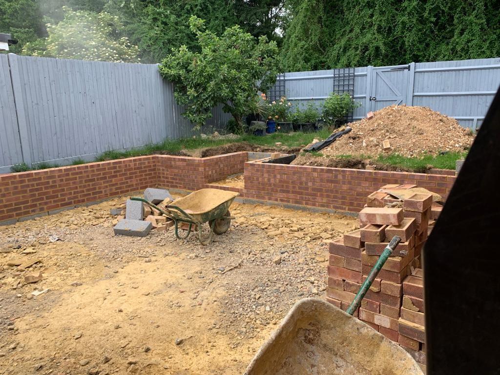 Garden excavation with brick retaining wall under construction