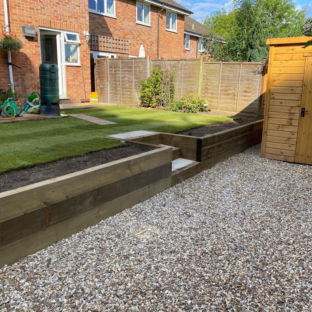 Tiled backyard patio with wooden shed and lawn